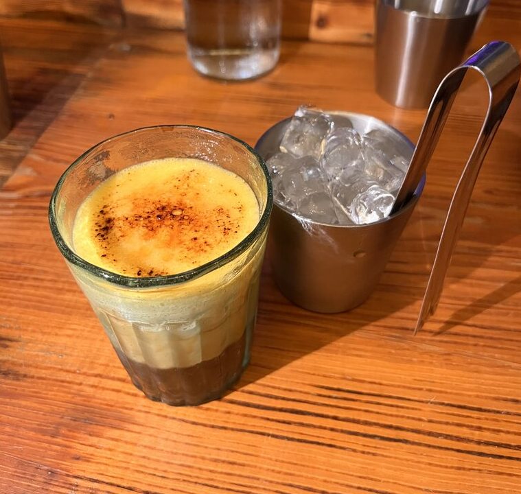 Vietnamese Egg Coffee (Cà Phê Trứng) with a creamy egg yolk topping floating on freshly brewed coffee.