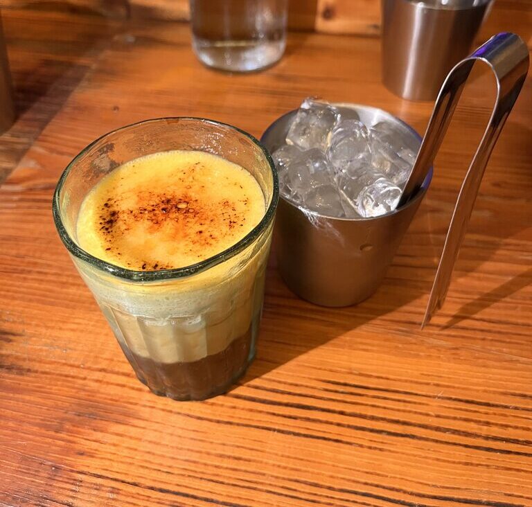 Vietnamese Egg Coffee (Cà Phê Trứng) with a creamy egg yolk topping floating on freshly brewed coffee.