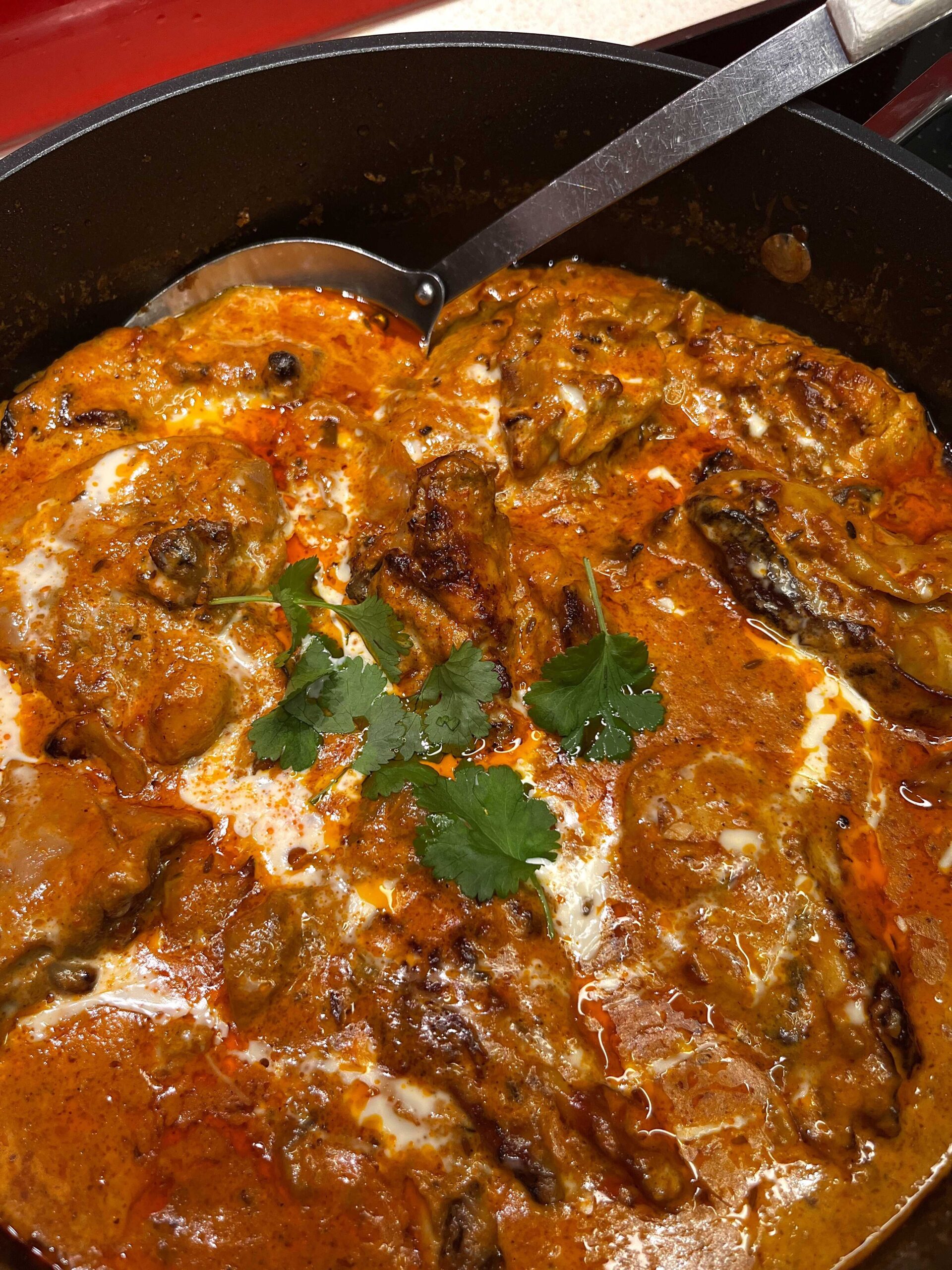 Rich and creamy Butter Chicken (Murgh Makhani) served with fluffy basmati rice and fresh coriander. A classic Indian curry with tender chicken in a spiced tomato and butter sauce.